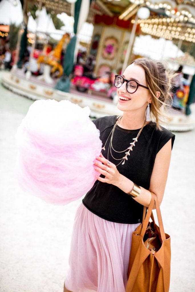Woman with cotton candy at the amusement park